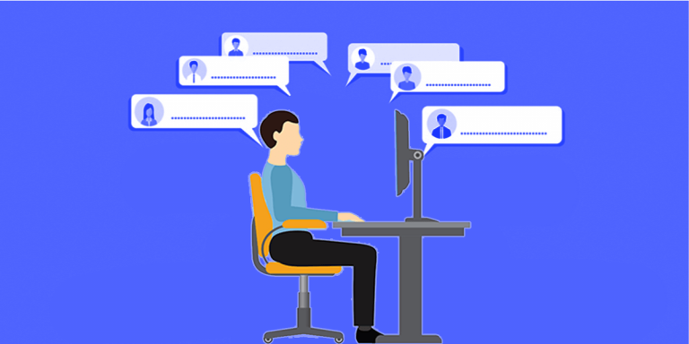 a guy working on a laptop with more people